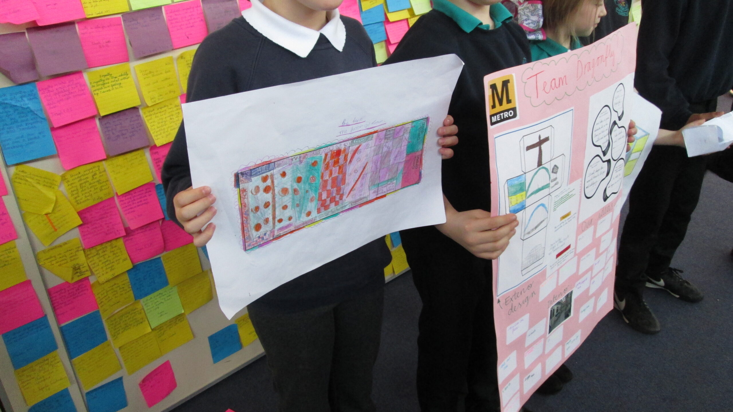 School pupils holding posters of Metro safety messages