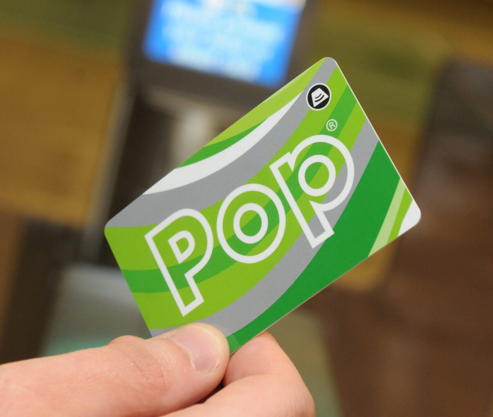 Green Corporate Pop card being held on a gateline