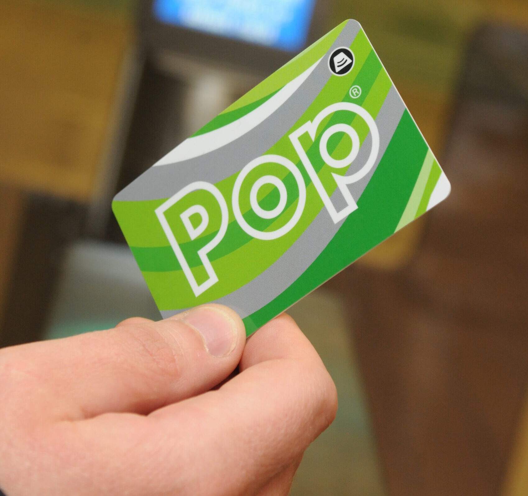 Green Corporate Pop card being held on a gateline