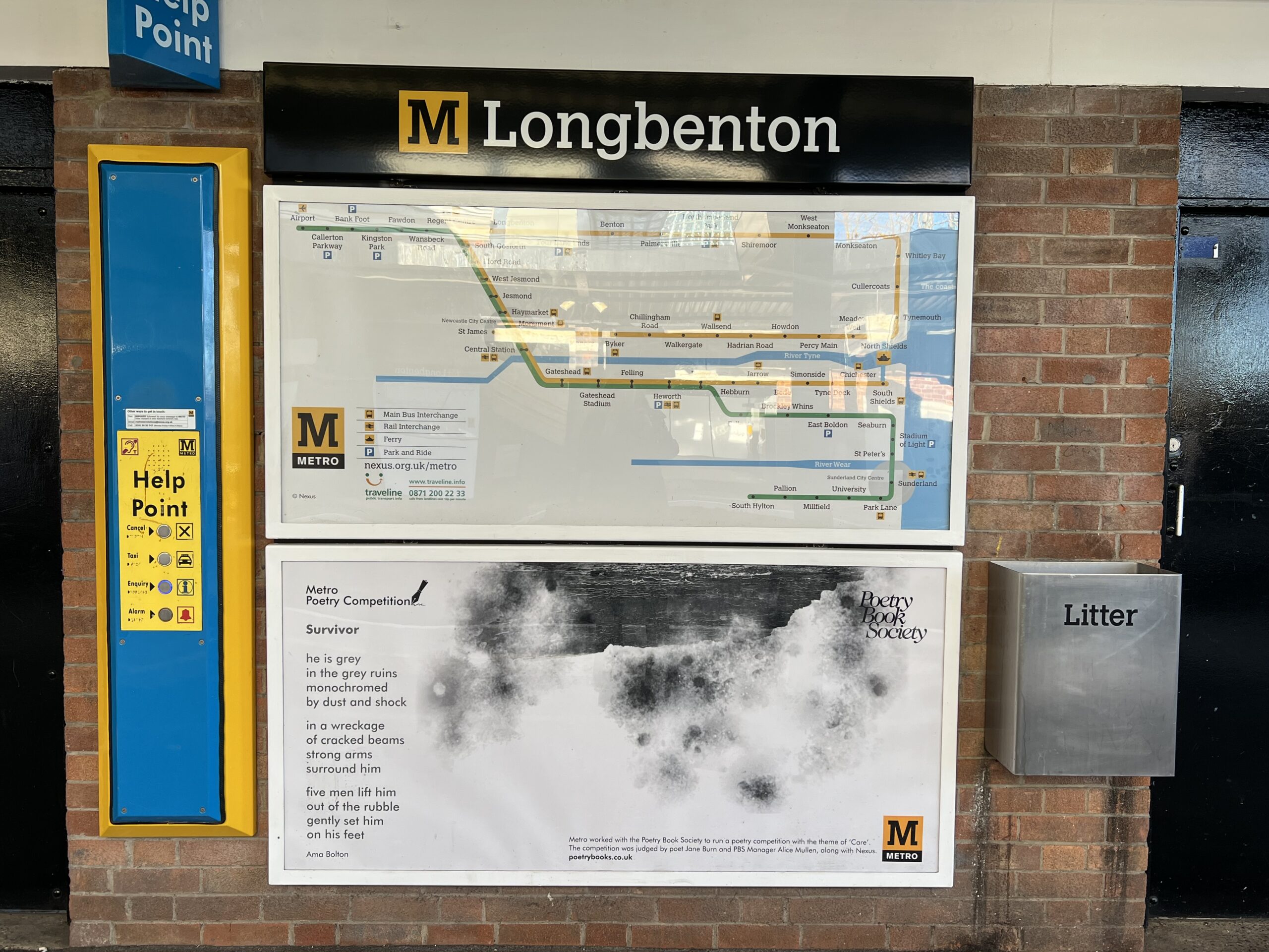 A Metro map and a framed poem on the platform at Longbenton Metro station