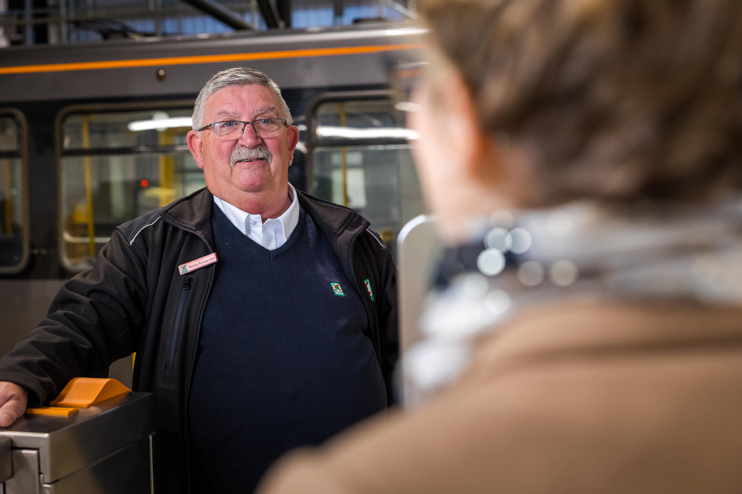 An image of a man infront of a train